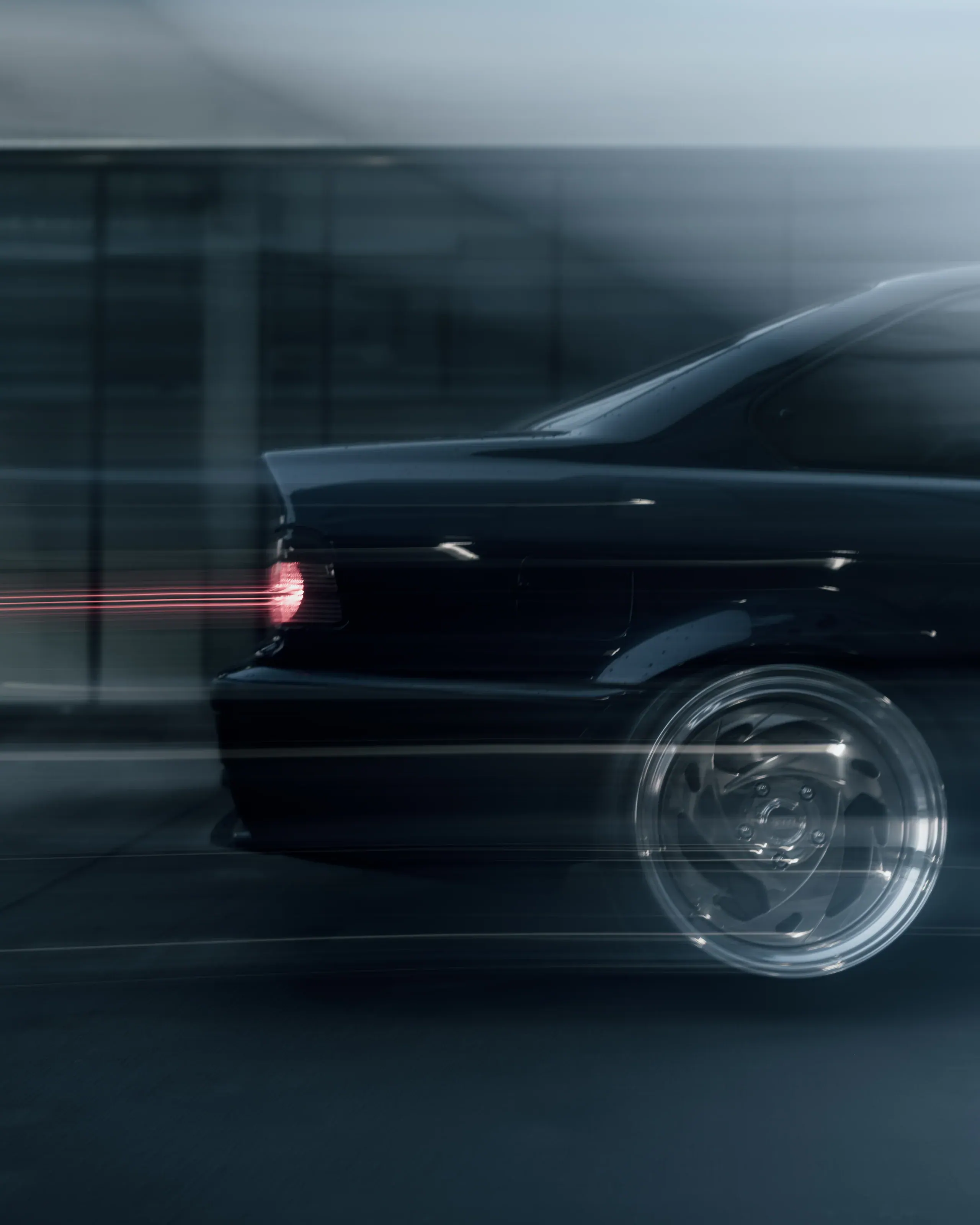 Tył BMW E36 przecięty poziomym rozmyciem i czerwonym światłem lampy.